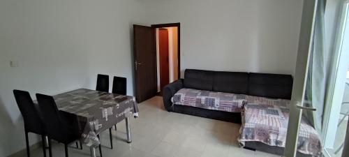a living room with a couch and a table at Ap Nada in Rogoznica
