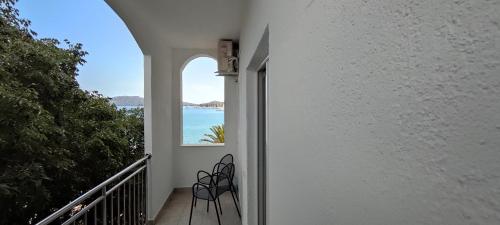 a balcony with two chairs and a view of the ocean at Ap Nada in Rogoznica