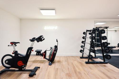a gym with treadmills and elliptical machines at Hotel Mariënhage in Eindhoven