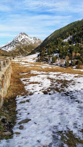 a snow covered field with a mountain in the background at SOLDEU cosy home in Soldeu