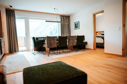 a living room with a dining room table and chairs at Carpe Solem Rauris by ALPS RESORTS in Rauris