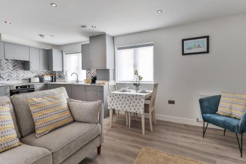 a living room with a couch and a table in a kitchen at Finest Retreats - 11 Belle House in Filey