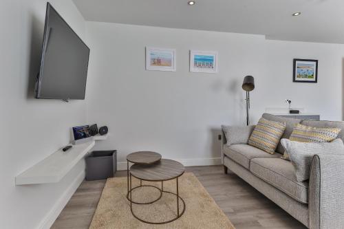 a living room with a couch and a table at Finest Retreats - 11 Belle House in Filey