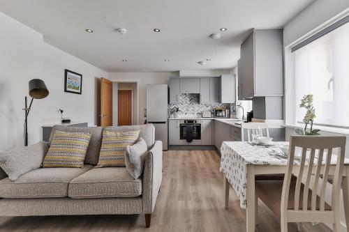 a living room and kitchen with a couch and a table at Finest Retreats - 11 Belle House in Filey