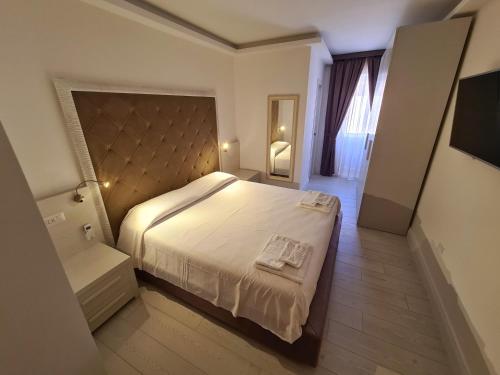 a bedroom with a large bed in a room at L'Isola nel Parco Boutique Rooms & Apartments in La Maddalena