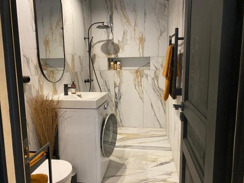 a white bathroom with a sink and a toilet at Cozy beach house Jurmala in Jūrmala