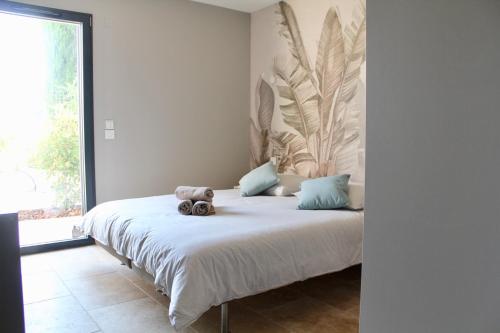 a teddy bear sitting on a bed in a bedroom at L'ete Indien 2 in Sanary-sur-Mer