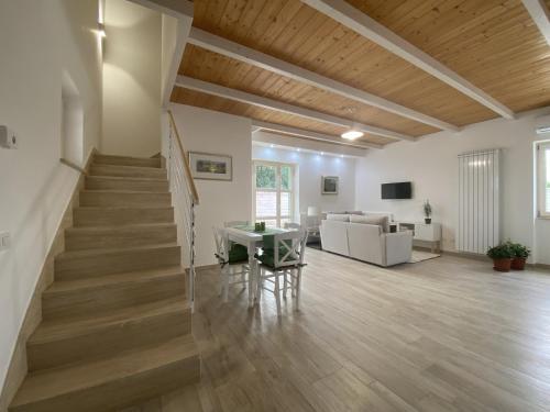 a living room with a staircase and a couch at Relais Gregorio in Paternopoli
