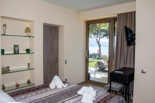 a bedroom with a bed and a view of the ocean at Glyfada Beach Hotel in Glyfada