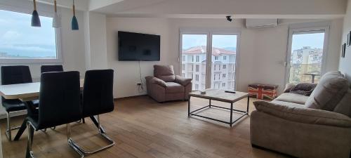 a living room with a couch and a table at Svir Skyline Apartment No 39 in Ohrid