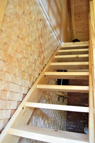 a set of stairs in a room with wooden walls at Apartment Mateja in Mokra Gora