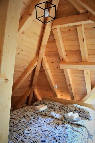 a room with a bed in a wooden attic at Apartment Mateja in Mokra Gora