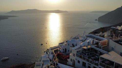 an aerial view of the ocean and buildings at NEOKLASSIKO KOUKOULI in Fira