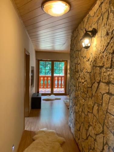a living room with a stone wall and a light at Penzion Bawaria in Horní Lomná