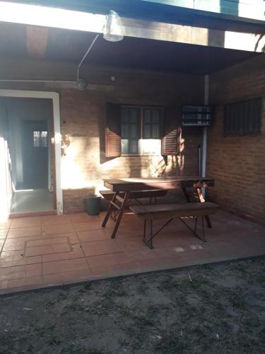 a picnic table on a patio in front of a building at Hermosa Casita II Paso Patria in Paso de la Patria