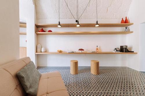 a living room with a couch and wooden shelves at Infinito Bianco in Polignano a Mare