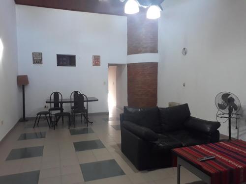 a living room with a couch and a table at Hermosa Casita II Paso Patria in Paso de la Patria