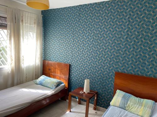 Posteľ alebo postele v izbe v ubytovaní Appartement à Mermoz, nettoyage journalier gratuit
