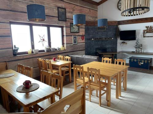 a dining room with wooden tables and chairs at Haus Izabella in Filzmoos