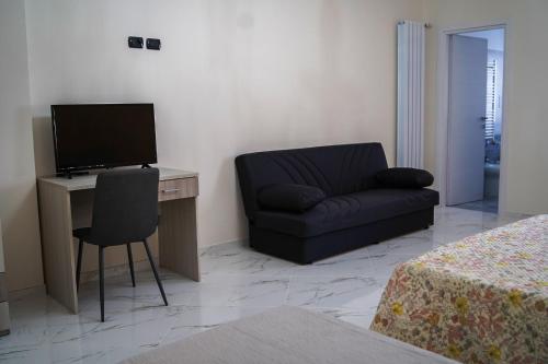 a room with a couch and a desk and a chair at Demetra Azienda Agricola in Padula