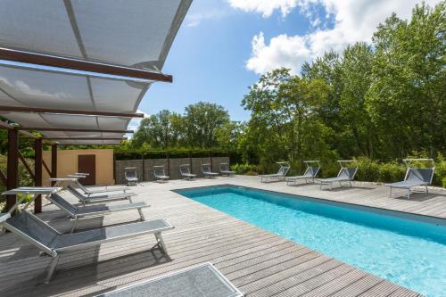 a patio with a pool and lounge chairs and a swimming pool at Chateau des Ducs de Joueuse, BW Signature Collection in Couiza