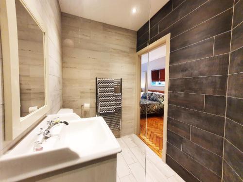 a bathroom with a white sink and a shower at St Paul's Studios apartment in London