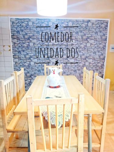 a wooden table with chairs and a tea pot on it at Posada MARTINEZ in Corrientes