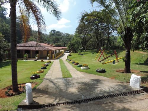 a park with a playground and a house at Sítio Sebastião Pereira in Jambeiro