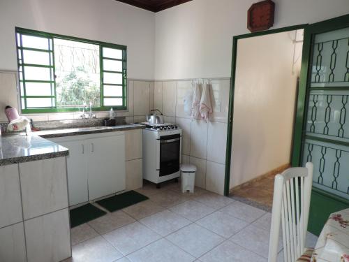 a kitchen with a sink and a stove top oven at Sítio Sebastião Pereira in Jambeiro