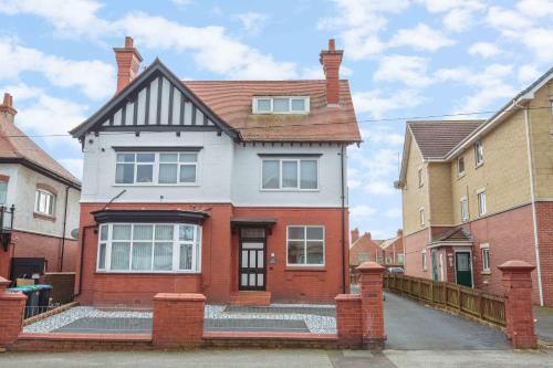 a red and white house with a brick at Cherry Property - Mulberry Suite in Blackpool