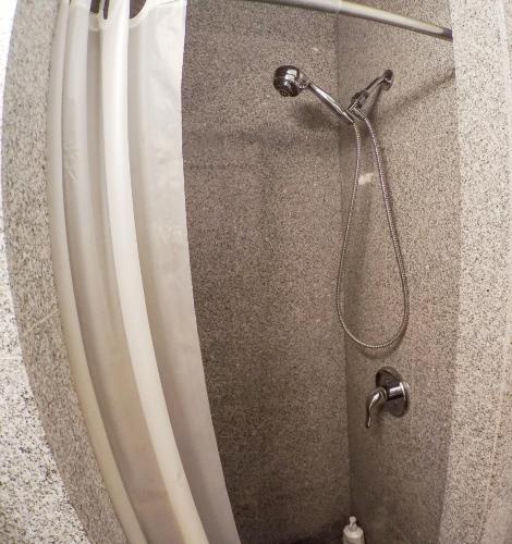a shower with a shower curtain and a shower head at Studios in New York in New York
