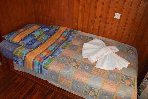 a bed with two towels on top of it at Apartment in Afiartis I in Karpathos Town