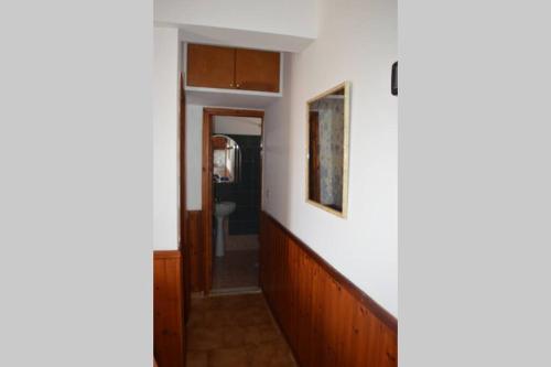 a hallway with a stairway leading to a bathroom at Apartment in Afiartis I in Karpathos