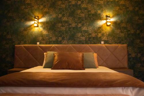 a bedroom with a bed with two lights on the wall at Golden Mirror in Lamego