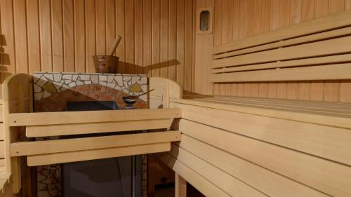 a sauna with wood paneling and a stoneificialificialificialificialificialificial at Hotel Landhaus Ausswinkl in Russbach am Pass Gschütt