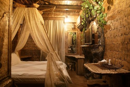 a bedroom with a canopy bed and a table at Boutique Fantasy in Tbilisi City