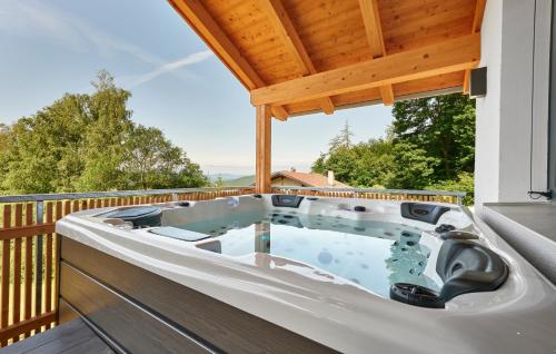 a hot tub on the deck of a house at Zeitlos in Bodenmais