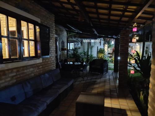 a patio with a table and chairs in a building at Chalé 17 - Porto do Sol - Pipa in Pipa