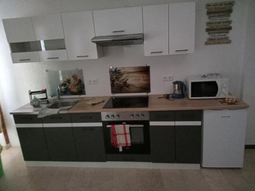 a kitchen with a sink and a stove top oven at da GIUSEPPE in Tuttlingen