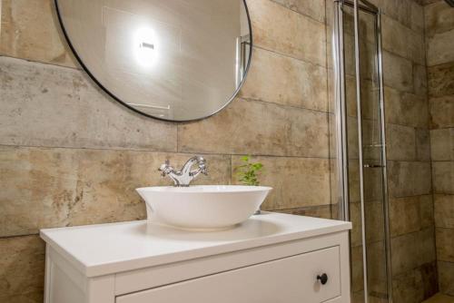 a bathroom with a sink and a mirror at Apartamentos Samitier Casa Cambra in Mediano