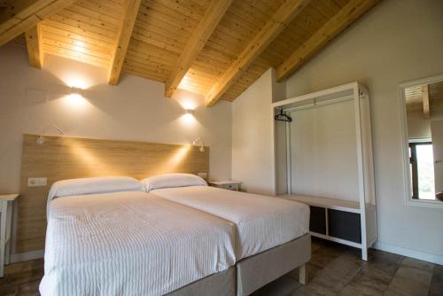 a bedroom with a large white bed in a room at Apartamentos Samitier Casa Cambra in Mediano
