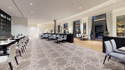 a restaurant with tables and chairs and a bar at Dorint Hotel Frankfurt/Oberursel in Oberursel
