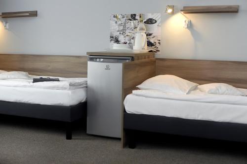 two beds sitting next to each other in a room at Hostel Helios in Września