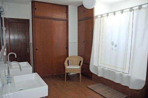 a bathroom with a sink and a toilet and a window at Villa with pool, 200m from beach in Cala Blanca