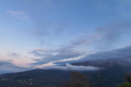 a view of a foggy valley with mountains and clouds at Traditional Stone House in Kissos Pelion in Kissós