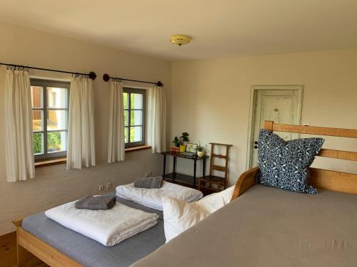 a bedroom with two beds and two windows at Little Vintage in Frankenberg