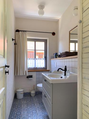 a bathroom with a sink and a toilet and a window at Little Vintage in Frankenberg