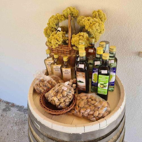 a display of bottles of wine and cookies on a barrel at Apartmani Dejan in Skradin