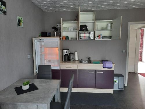 a kitchen with a table and a counter top at Zettler`s Ferienwohnung in Aichstetten