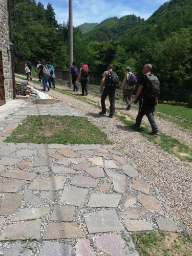 a group of people walking down a stone path at Relax a casa Beba in Reggello